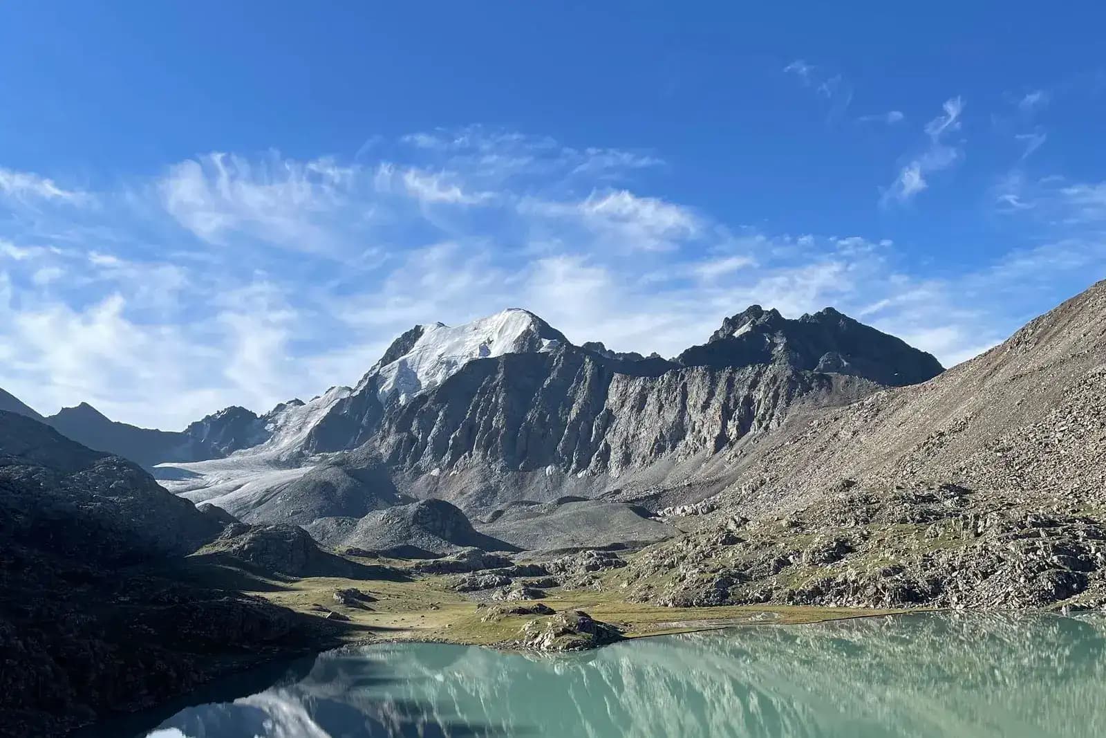 A turquoise mountain lake and a Tian Shan glacier in Kyrgyzstan
